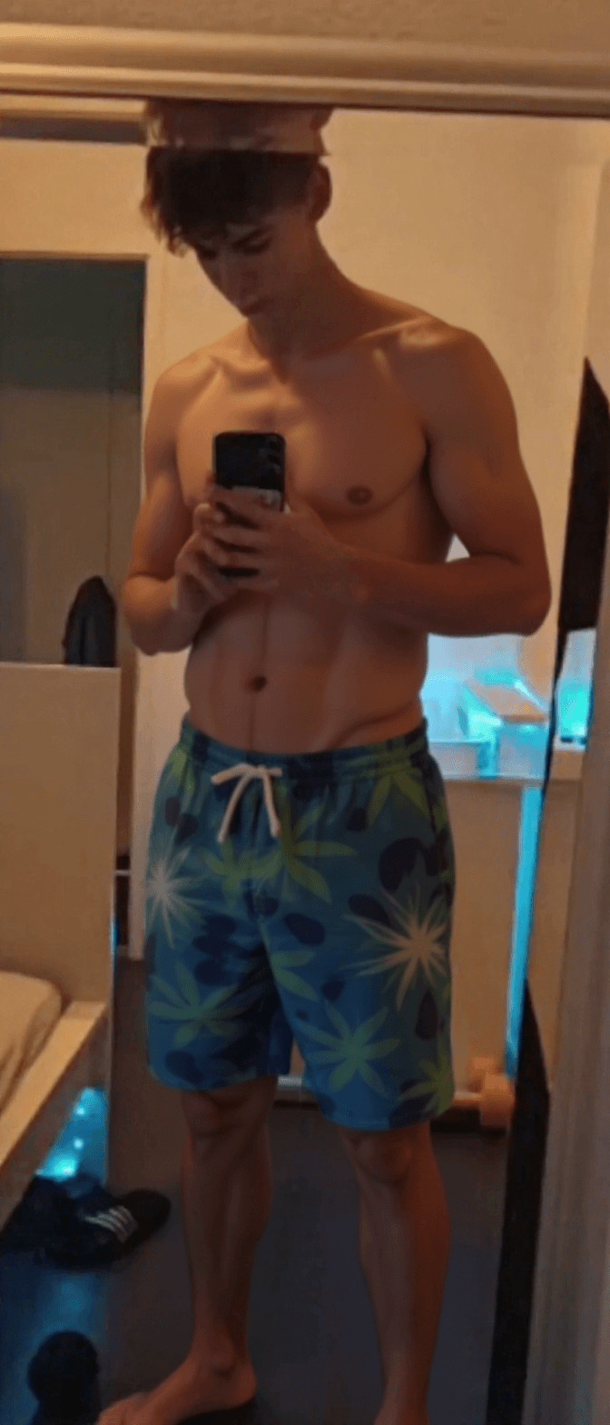 AI generated: Change the outfit into swimming trunks, as in beachwear.