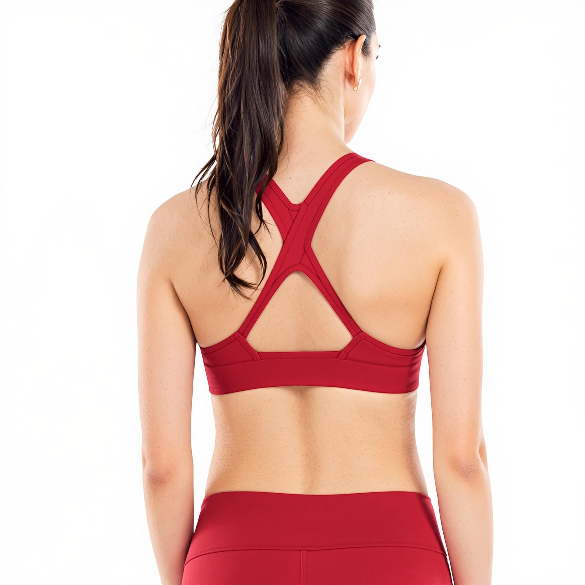 AI generated: a woman wearing red sports bra and matching leggings. Her hair is pulled back in a ponytail. The bac...
