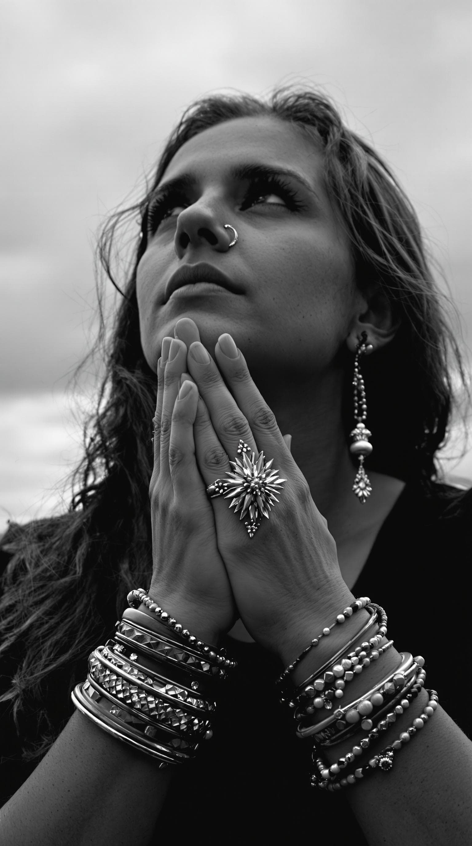 AI generated: Generate a black-and-white photograph featuring a person with long, wavy hair, dressed in a dark top...