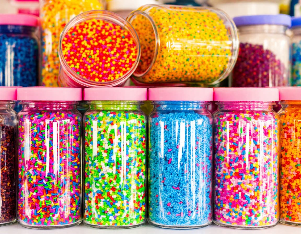 AI generated: Colorful jars of vibrant sprinkles arranged in a row