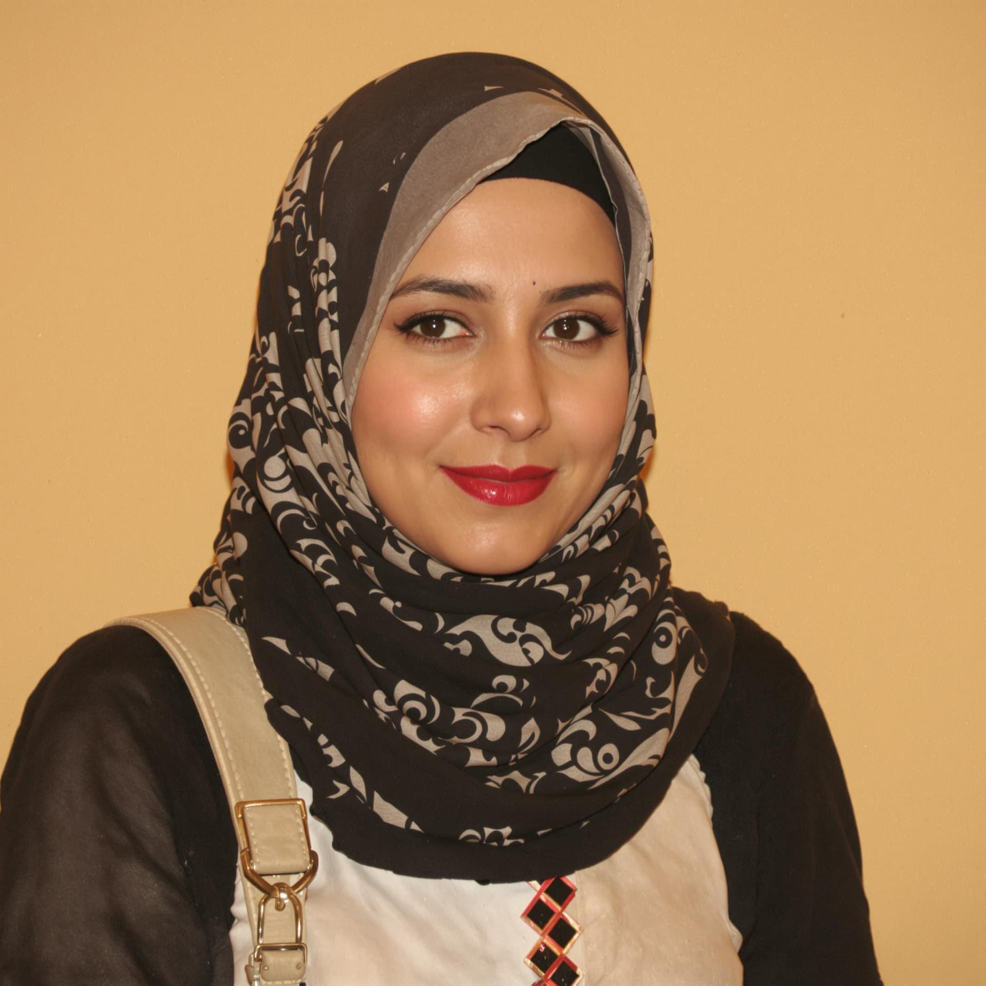 AI generated:  Arab woman 30 posing against a warm beige backdrop.