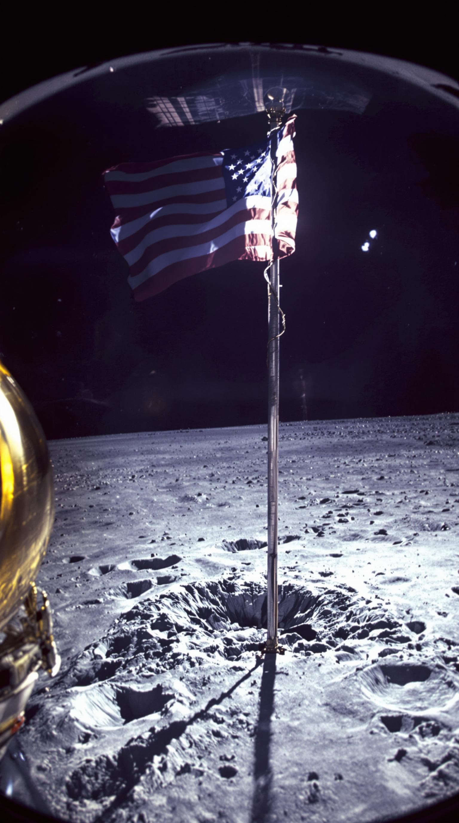AI generated: First person POV through helmet visor, astronaut gloves gripping American flag pole, boot prints vis...