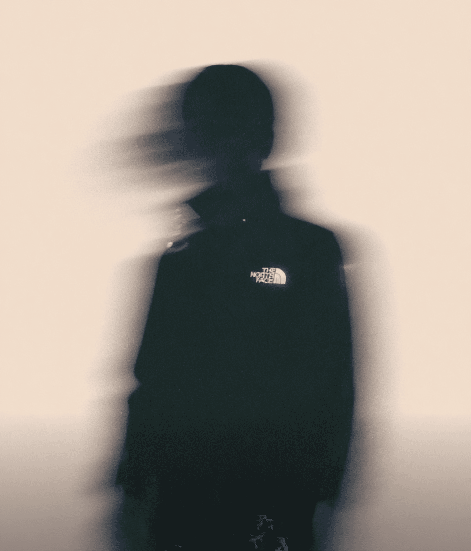 AI generated: A surreal, low-angle portrait of a man dressed in an eveningwear elegant black dress, standing again...