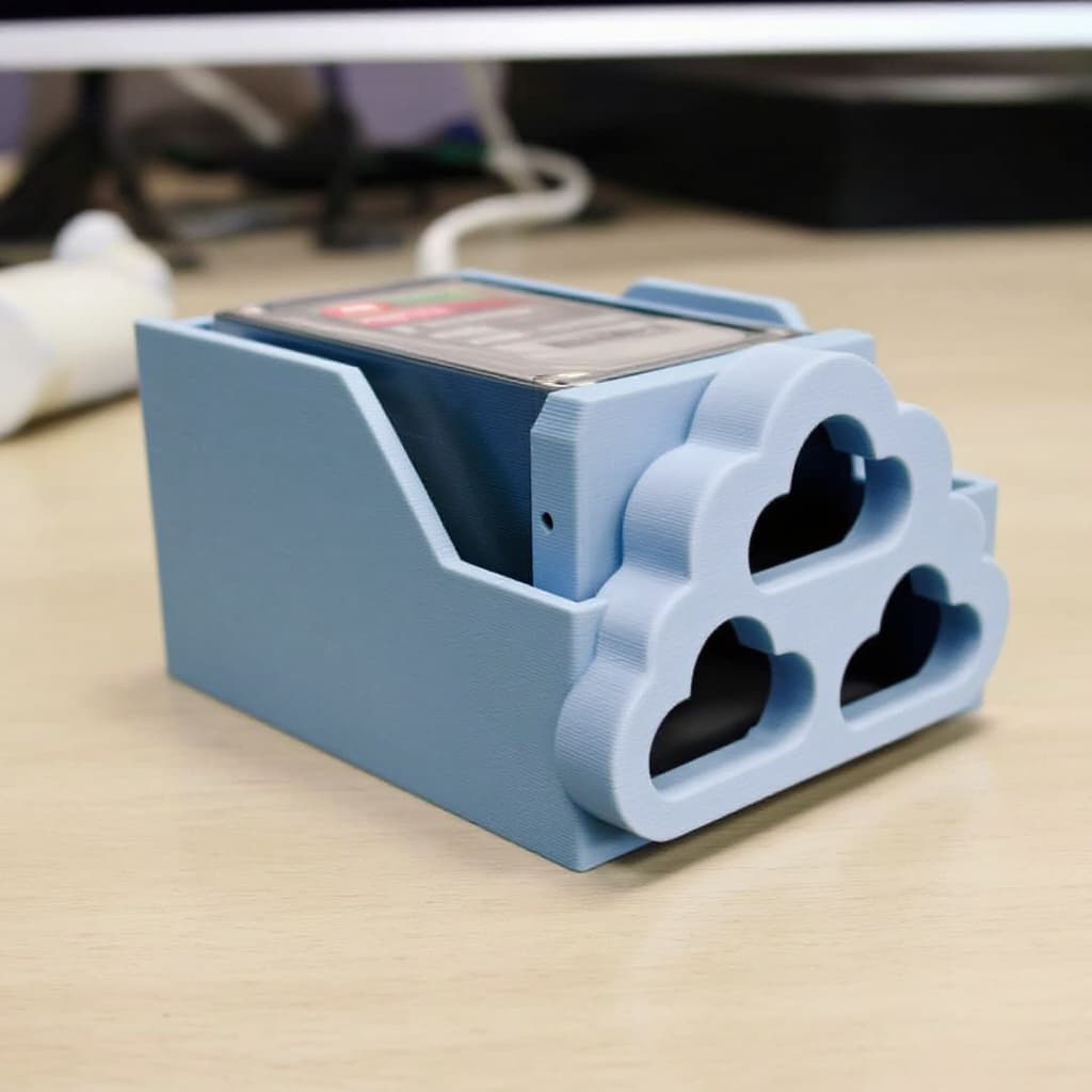 AI generated: a 3D-printed small external HDD rack with cloud-shaped holes in the side.