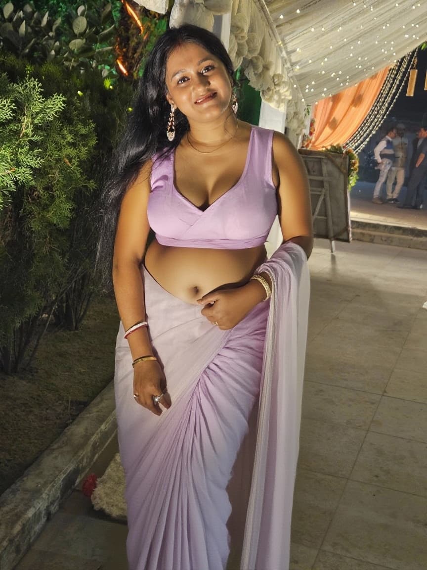 AI generated: Make the saree a sleeveless and the blouse very deep cut to show cleavage and also make the pallu ve...