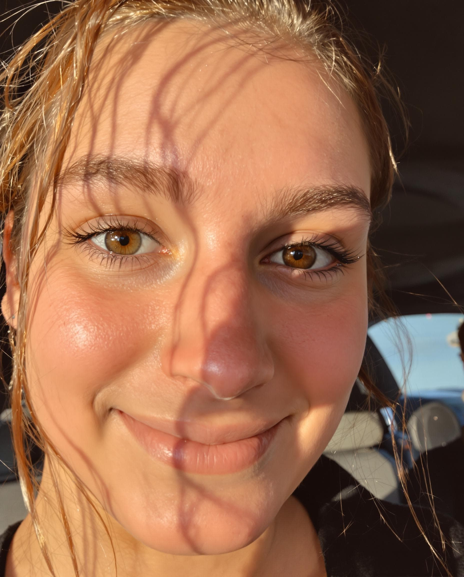 AI generated: low quality phone photo, snapchat, a girl's face with warm brown eye's, wavy auburn hair tied loosel...