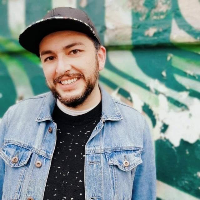 AI generated: Portrait of a smile and cute man on a graffiti background, green colors, hd.