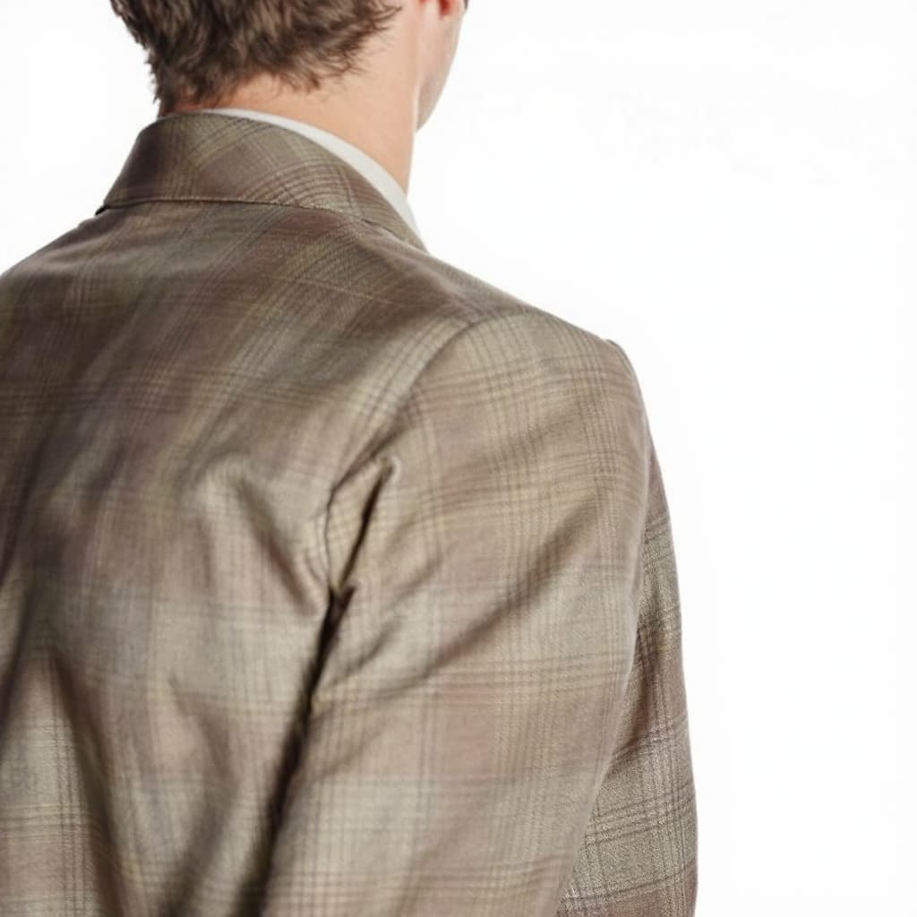 AI generated: A man wearing a brown and beige patterned suit, with a subtle plaid texture, against a plain white b...