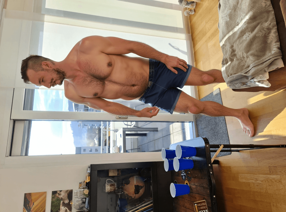 AI generated: Change the outfit to swimming trunks as in beachwear. The man having a Slightly hairy chest. Ultra r...