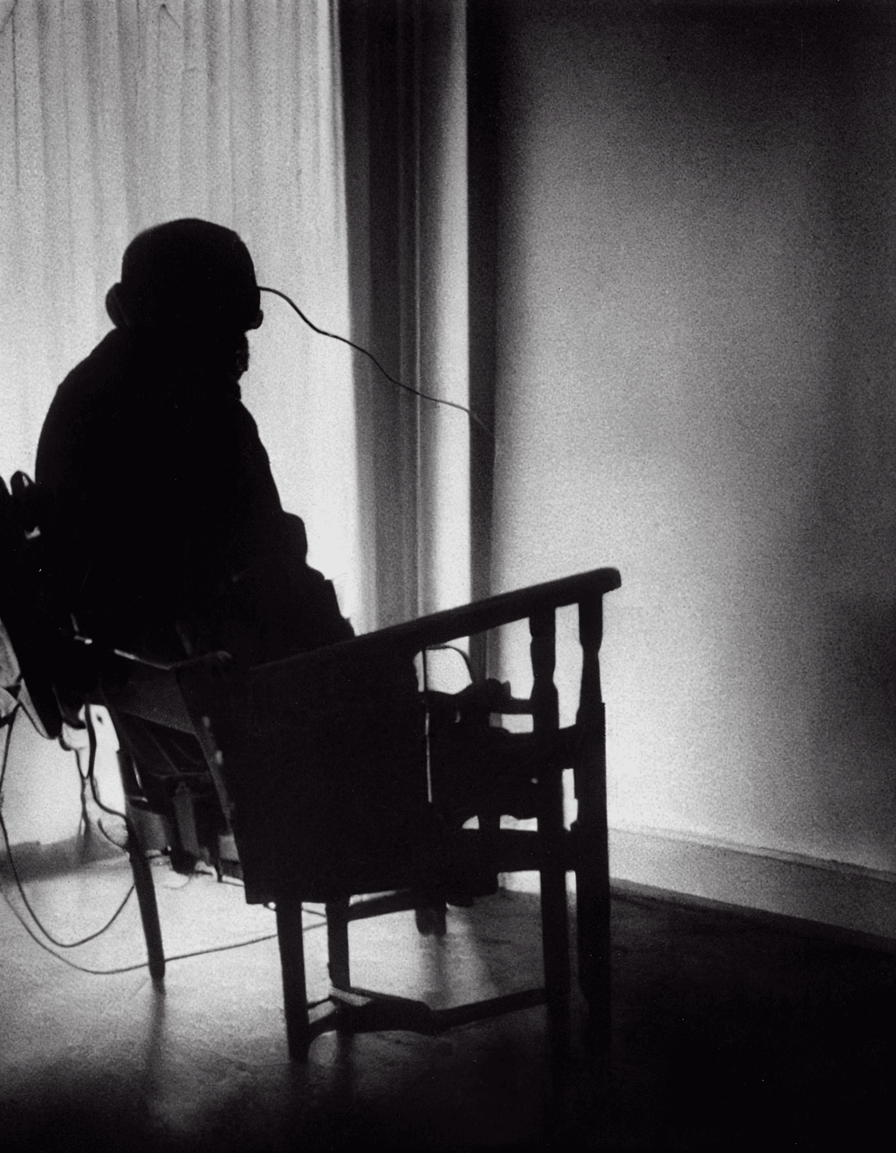 AI generated: old photo of middle aged man sitting in an electric chair and crying in pain, facing the camera, por...