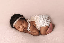AI generated: Black Baby Sleeping on a pink blanket