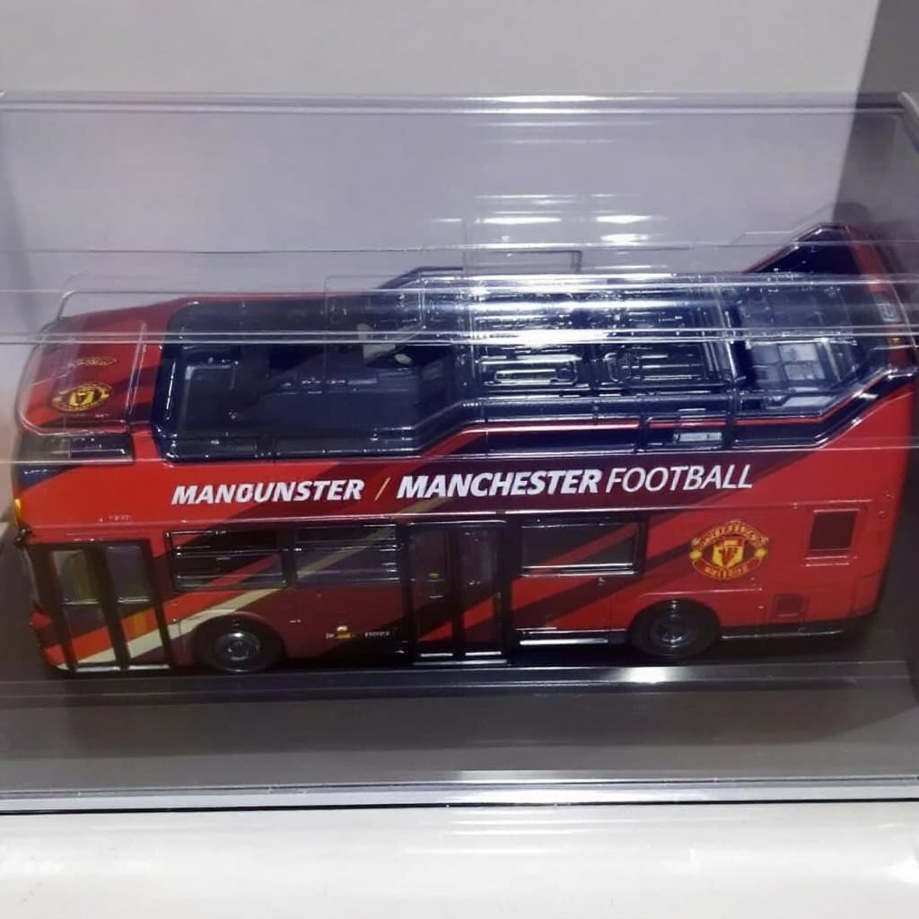 AI generated: Bus painted with Manchester United Football Club placed in a plastic case.