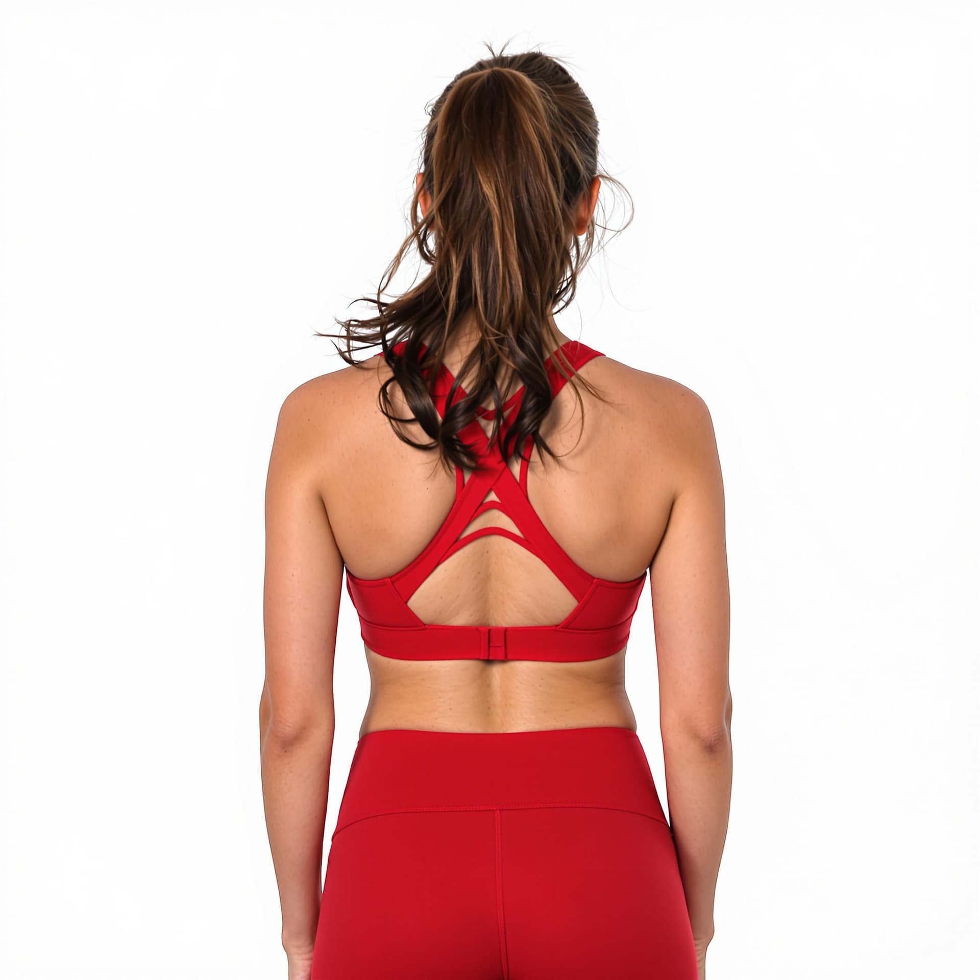 AI generated: a woman wearing red sports bra and matching leggings. Her hair is pulled back in a ponytail. The bac...