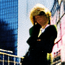 AI generated: Street style photo of a grunge style woman in the streets of 1990 Manhattan standing in front of a s...
