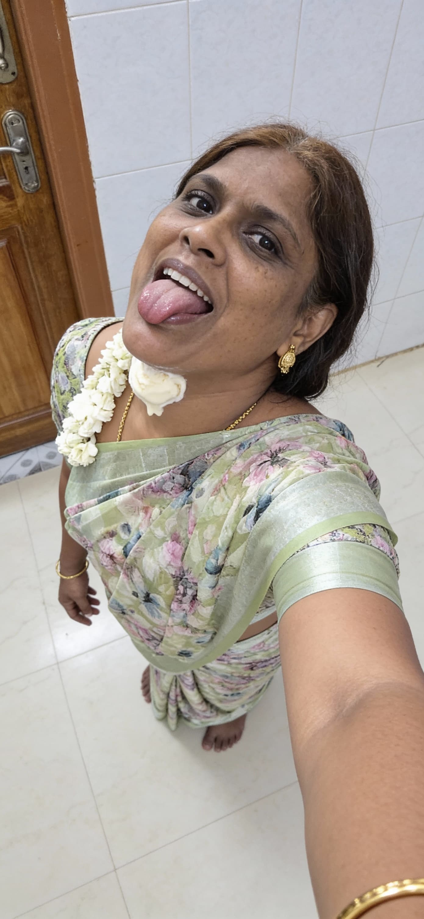 AI generated: iPhone selfie taken from a high overhead angle. A young woman kneels low, tilting her head back play...