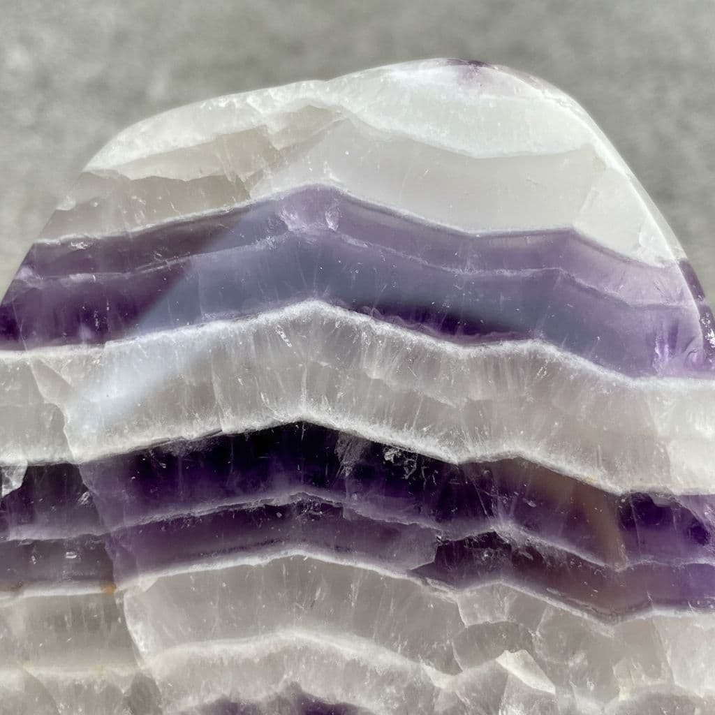 AI generated: Smooth Milky white crystal layered with purple crystal in horizontal lines