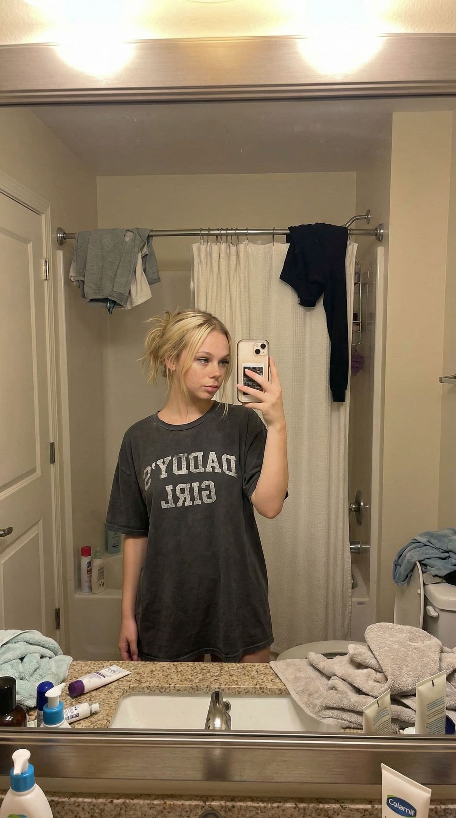 AI generated: mirror selfie ,in a bathroom, little messy 
bathroom details, daddys oversize t-shirt