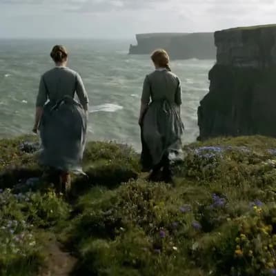 AI generated video: In rural Ireland, circa 1860s, two women, their long, modest dresses of homespun fabric whipping gen...