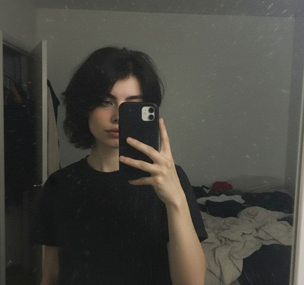 AI generated: stands in front of a mirror, capturing a selfie. The image quality is grainy, with a slight blur sof...