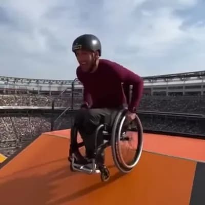 AI generated video: a video of a man in a wheelchair going down a mega ramp and doing a backflip
