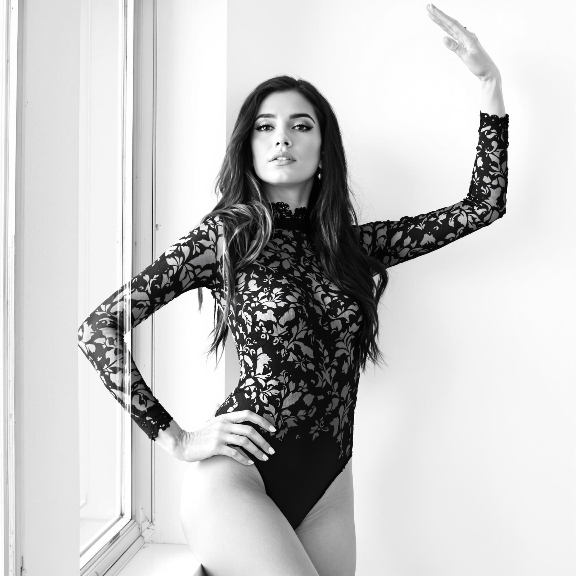 AI generated: Captured in a black and white monochromatic shot, a woman with long dark hair, wearing a black lace ...