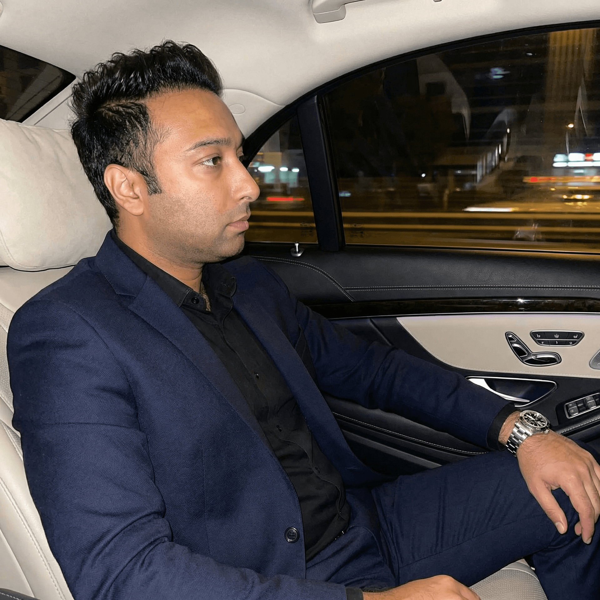 AI generated: Create a stylish night city lifestyle portrait of an adult man sitting in the back seat of a car, re...