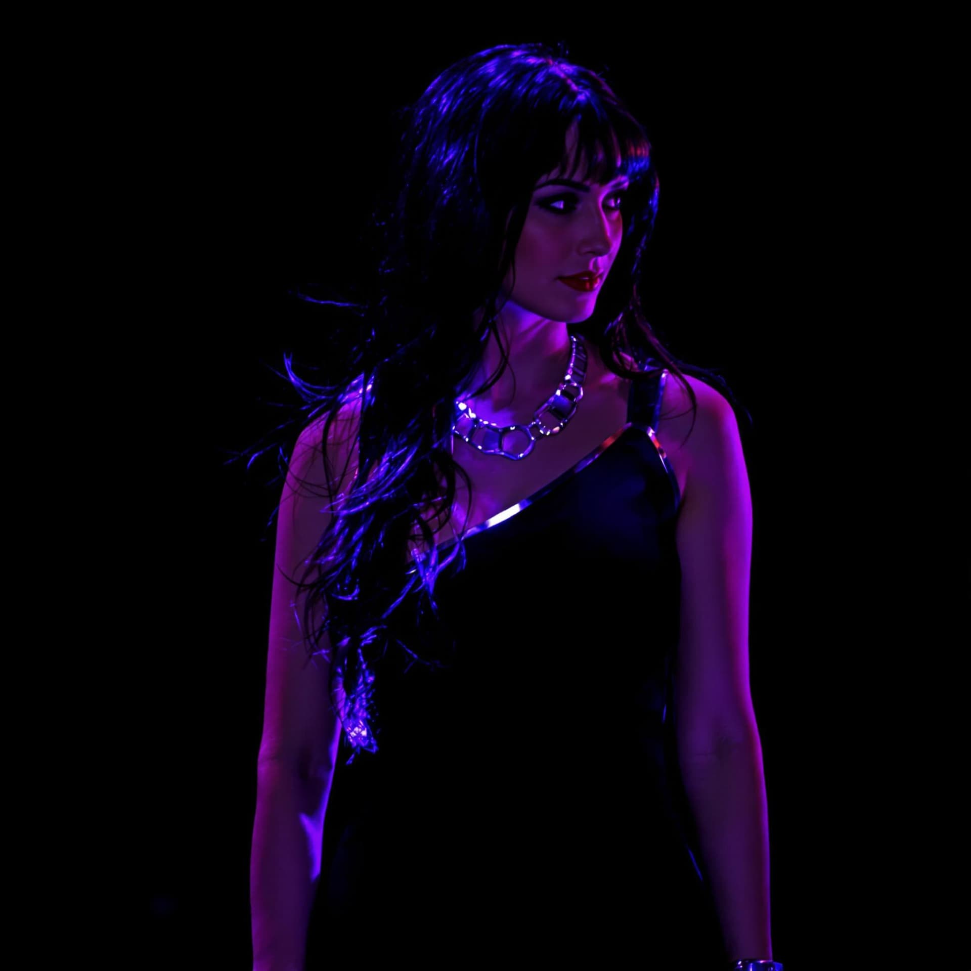 AI generated: Prompt
A woman stands in a black sleeveless dress, adorned with silver bracelets and a silver neckla...