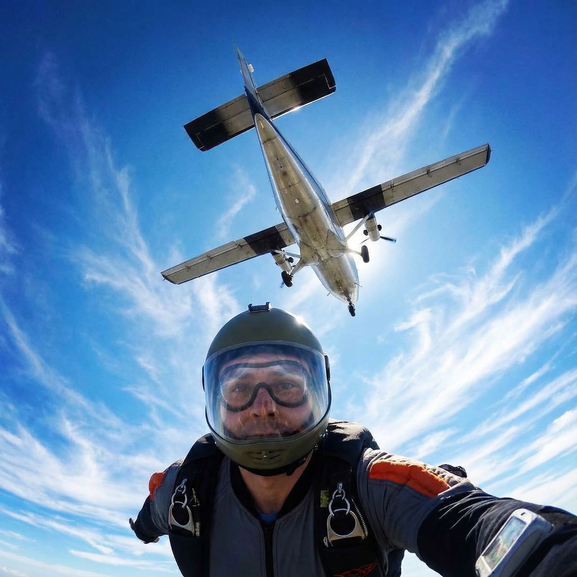 AI generated: A skydiver looking up and seeing the airplane above