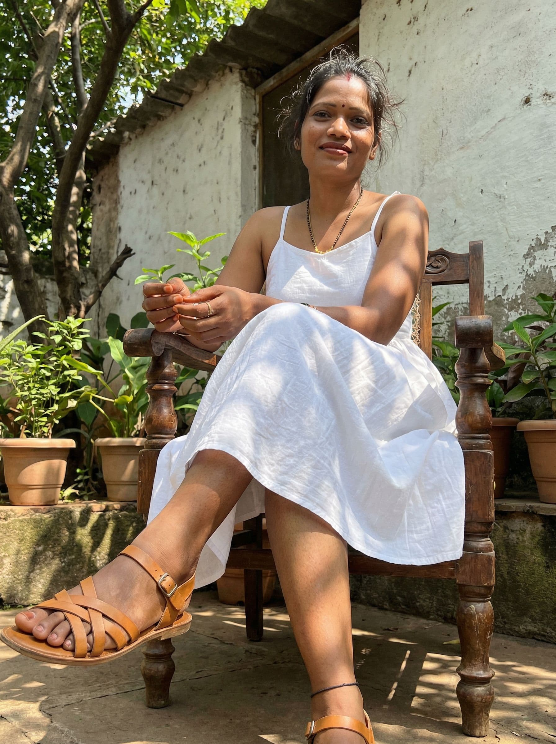 AI generated: A candid, low-angle shot of the uploaded woman with messy hair, wearing a white sundress and strappy...