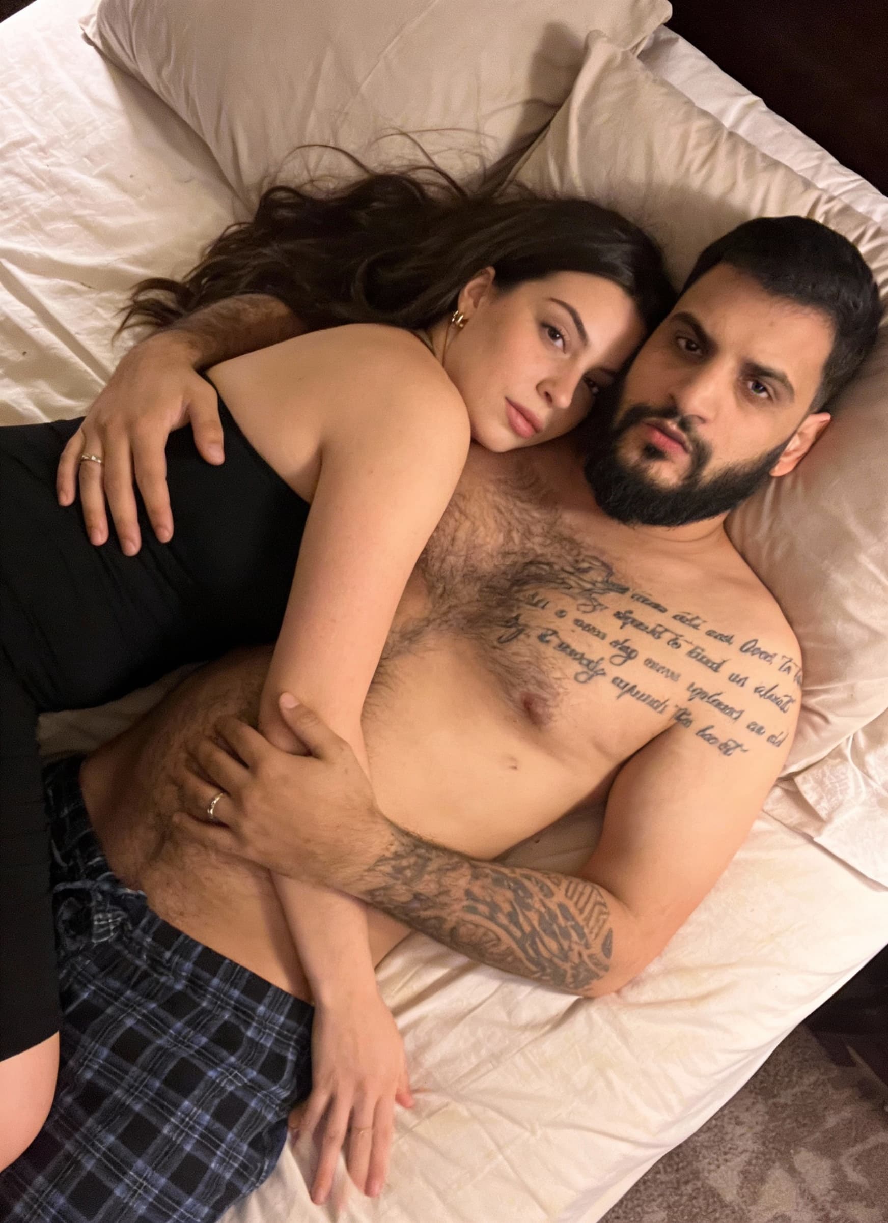 AI generated: Laying in bed on each other’s 