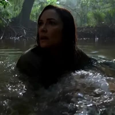 AI generated video: 

"A woman, partially submerged in water, slowly moves through a dense, shadowy environment. Her f...