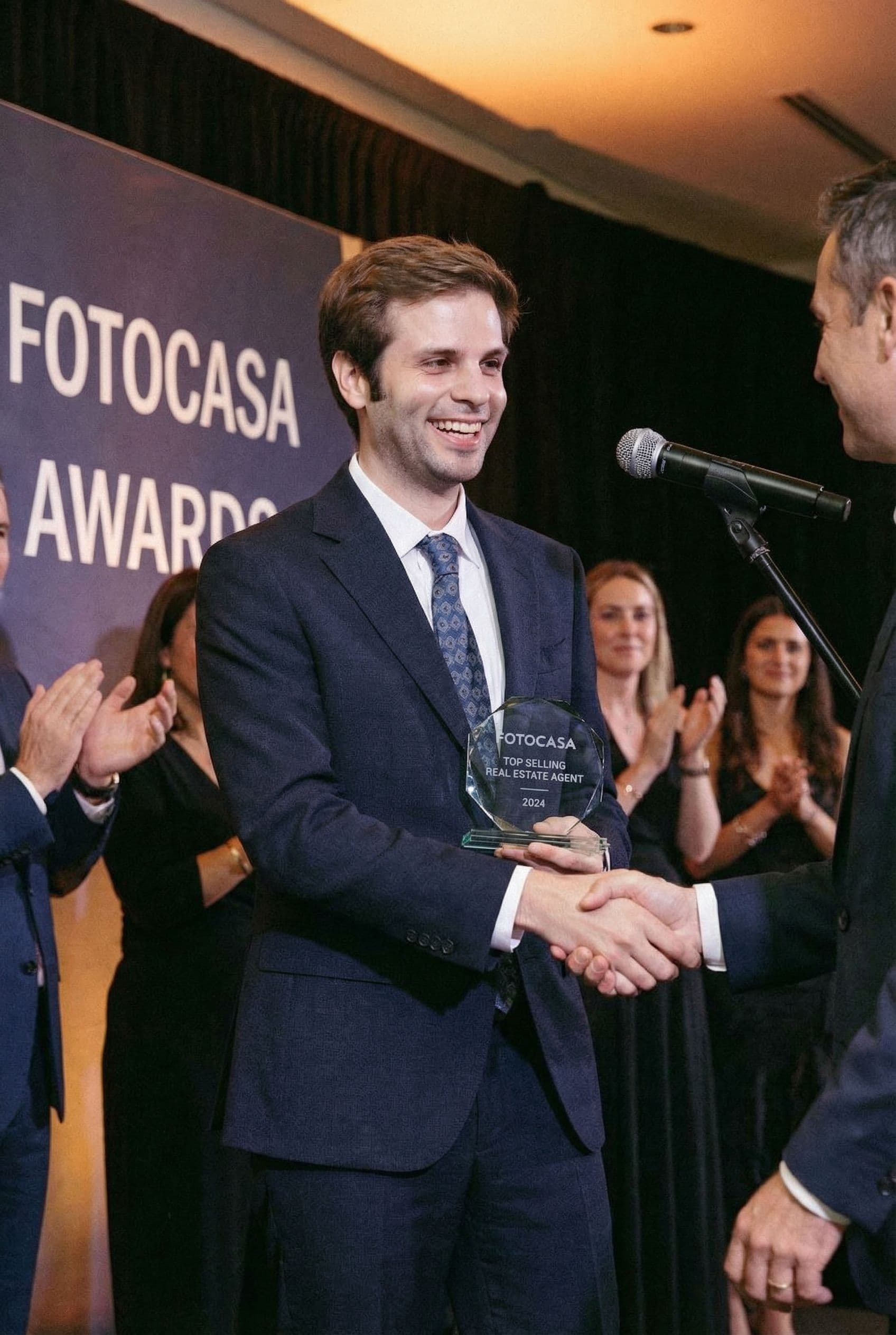 AI generated: The man is the top selling real estate agent of Fotocasa