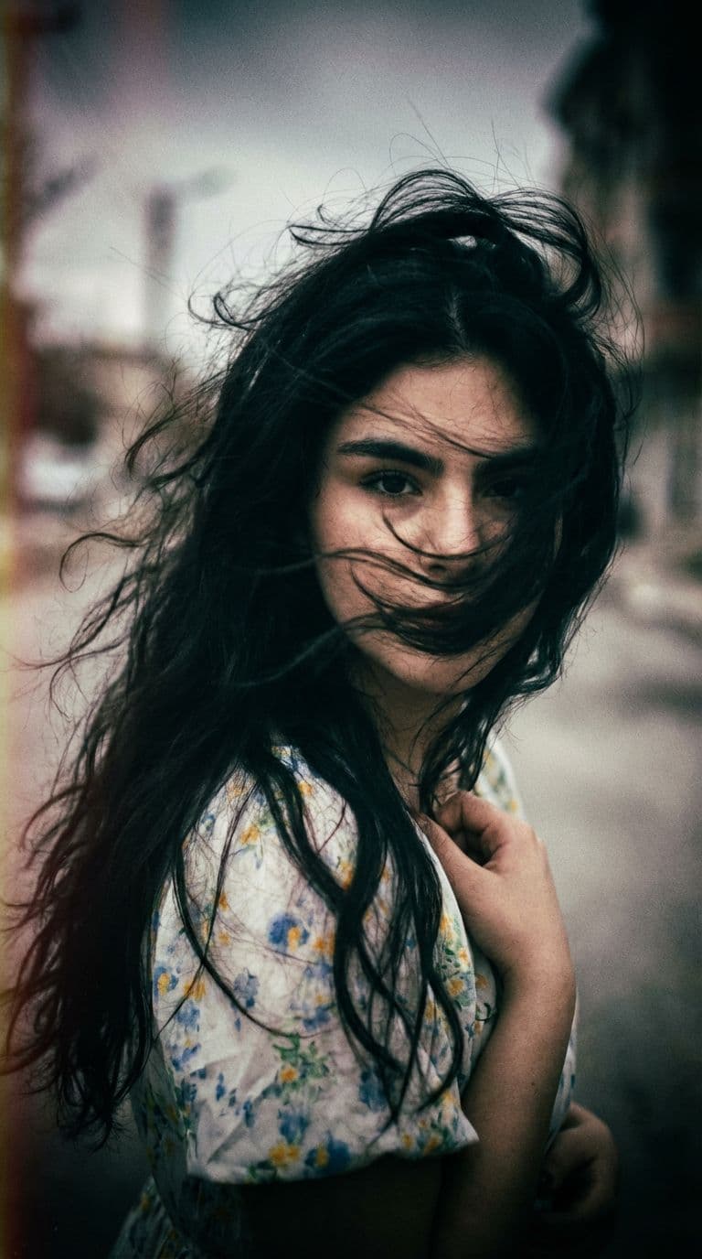 AI generated: a woman with long wild hair on a windy day, in the style of toy camera effects, haunting elegance, f...