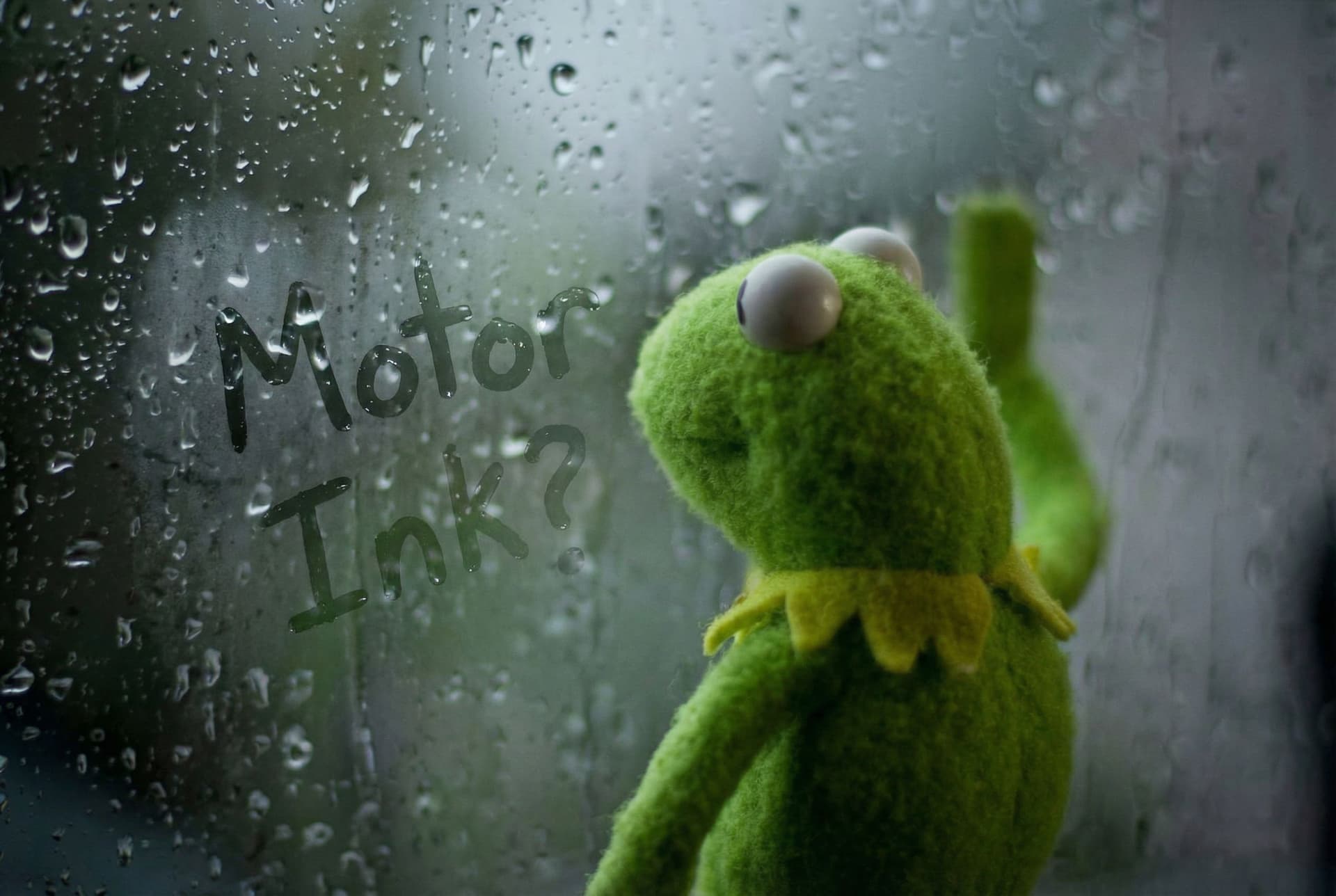 AI generated: Kermit the frog waiting for a response by the window. There is fog on the window and the name "Motor...