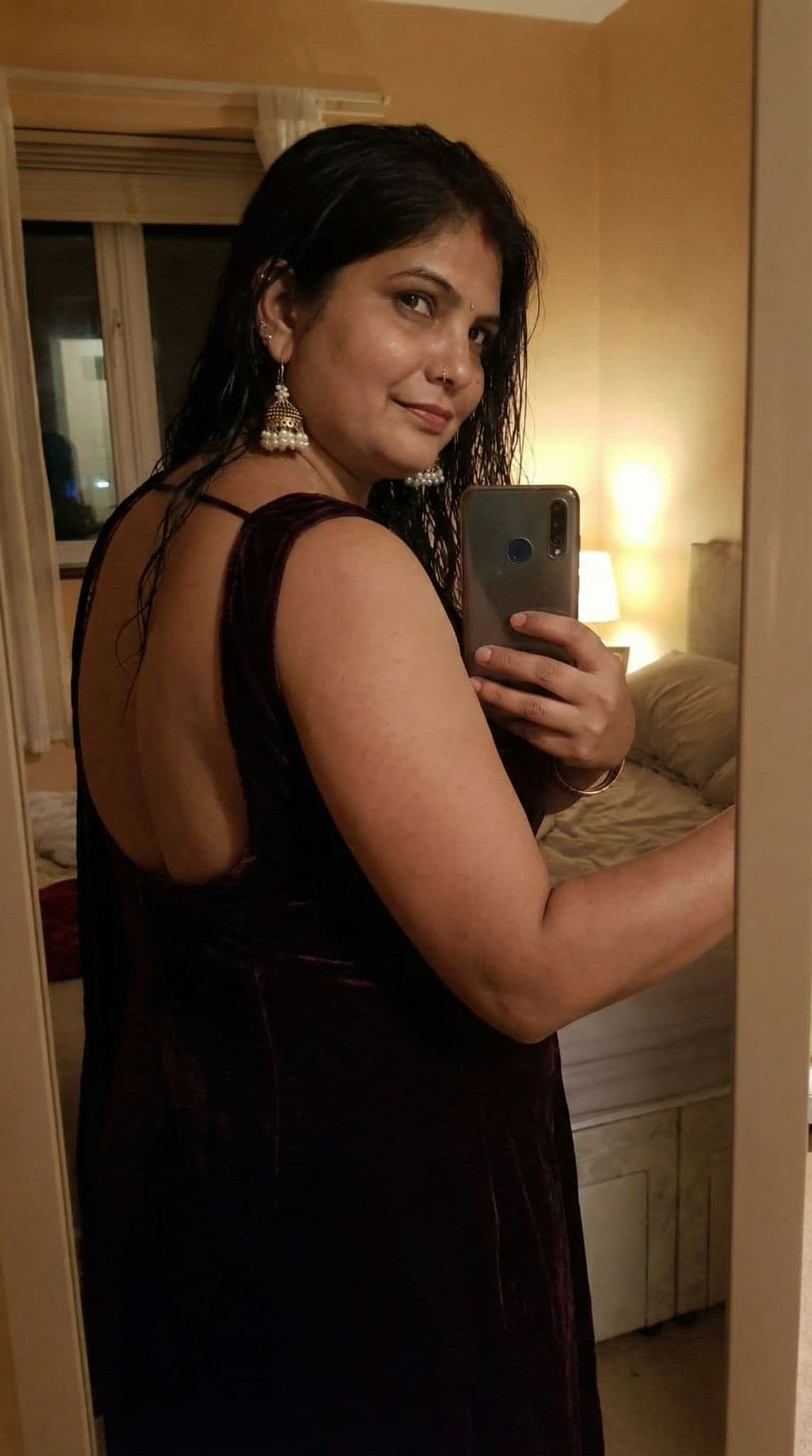 AI generated: Wearing backless dress taking a mirror selfie, seductive 