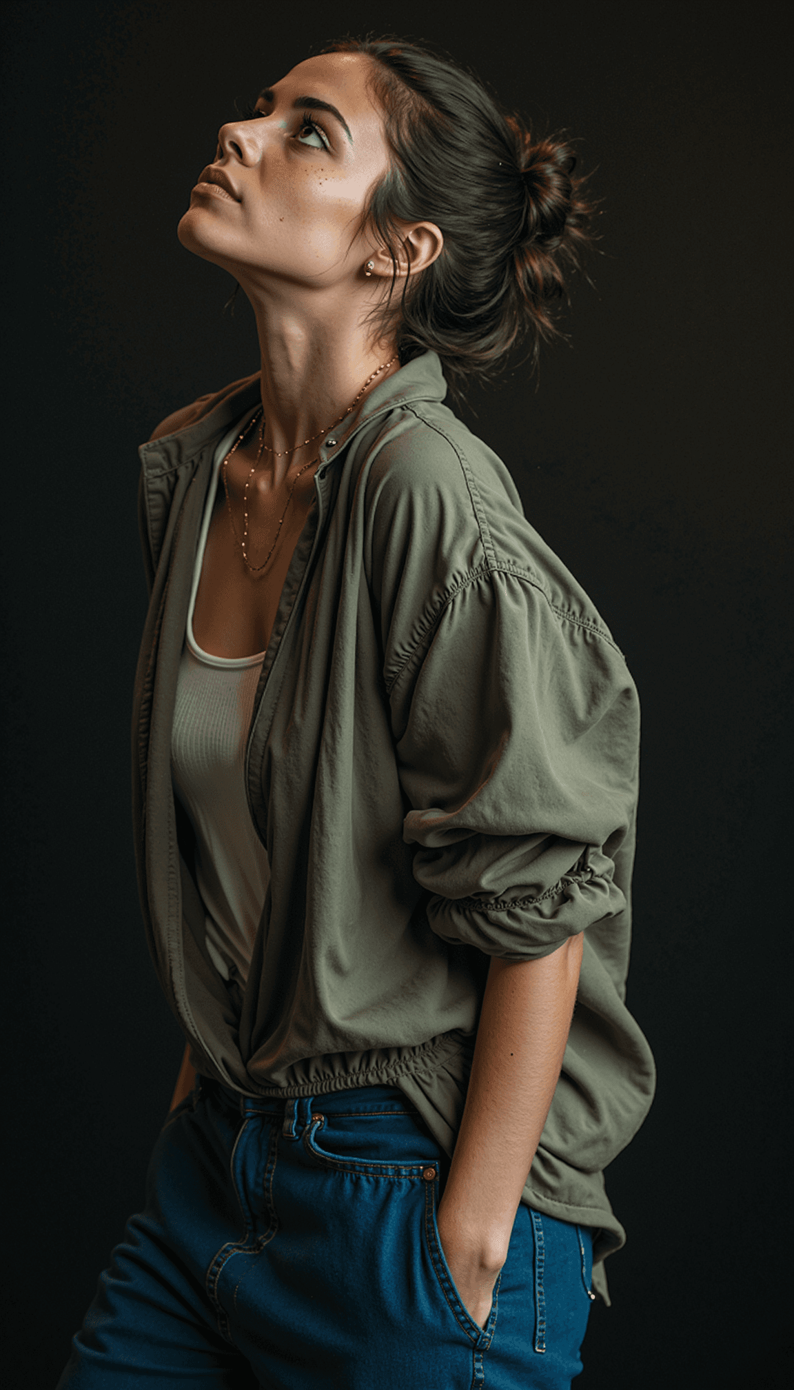 AI generated:  A side profile of a woman with hair in a messy bun, wearing an olive-green jacket over a white tank...
