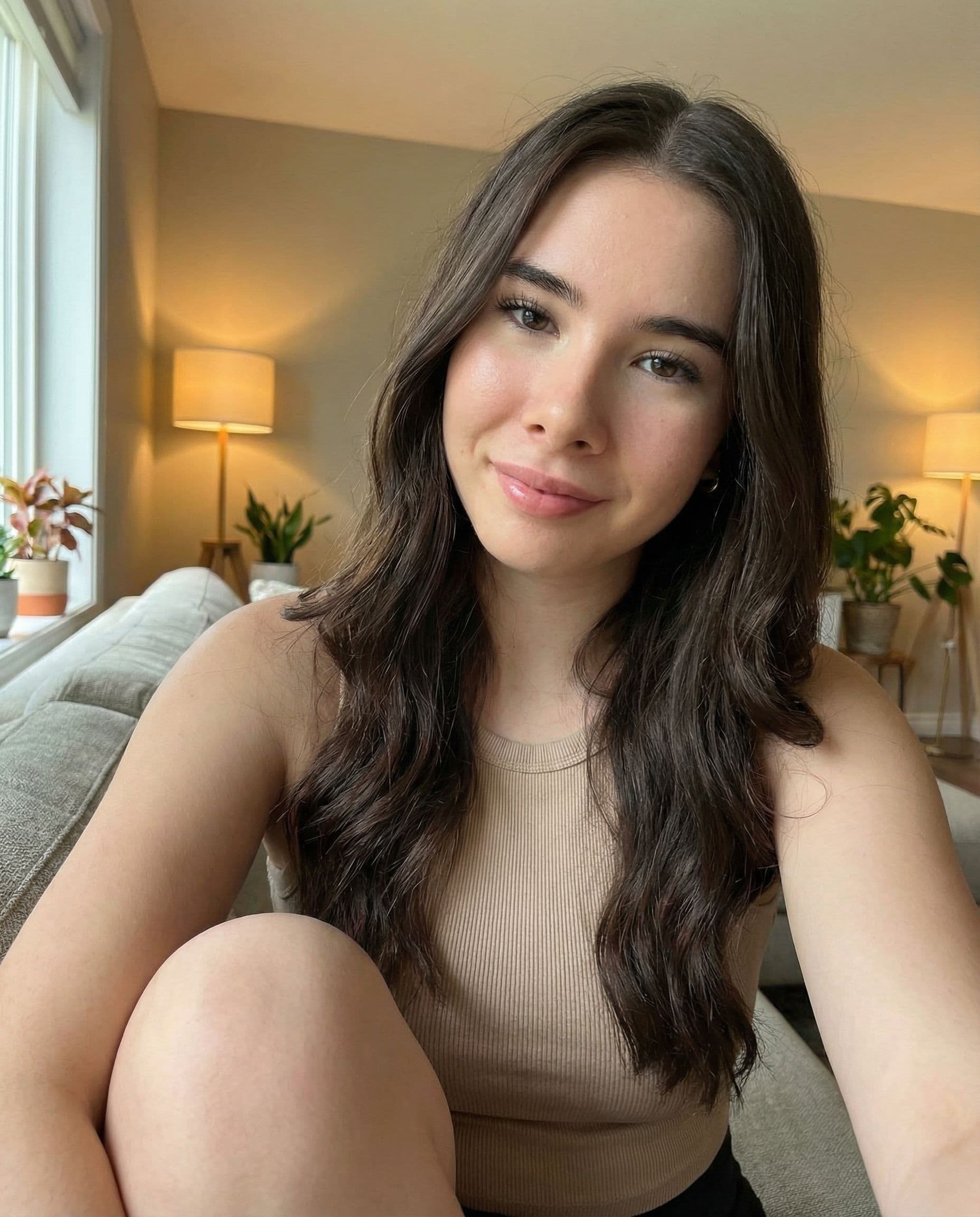 AI generated: A hyper-realistic selfie of a 22-year-old young brunette woman with deep brown eyes and long, wavy d...