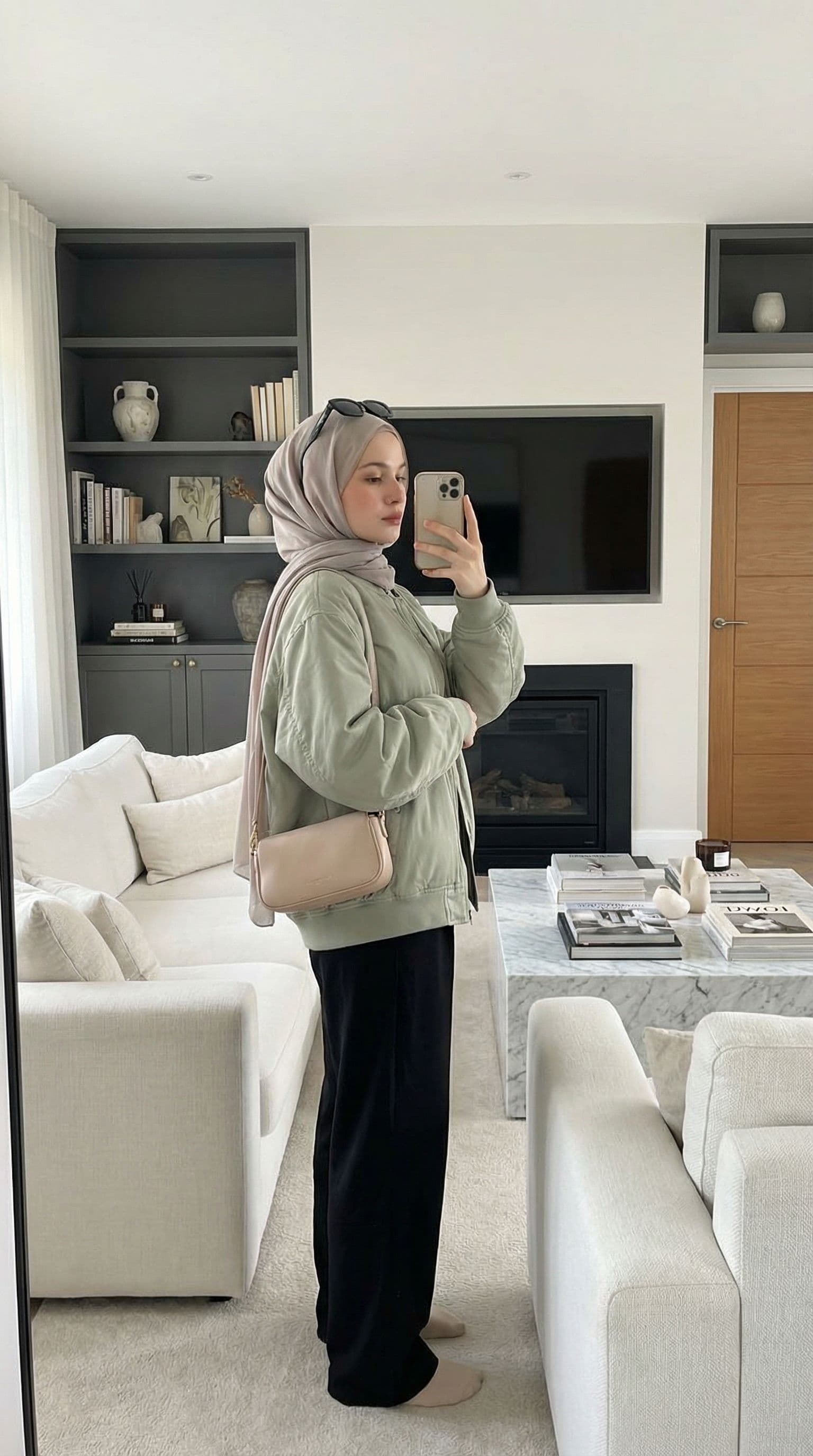 AI generated: A highly realistic, ultra-detailed indoor mirror selfie of a young hijabi woman standing in a modern...