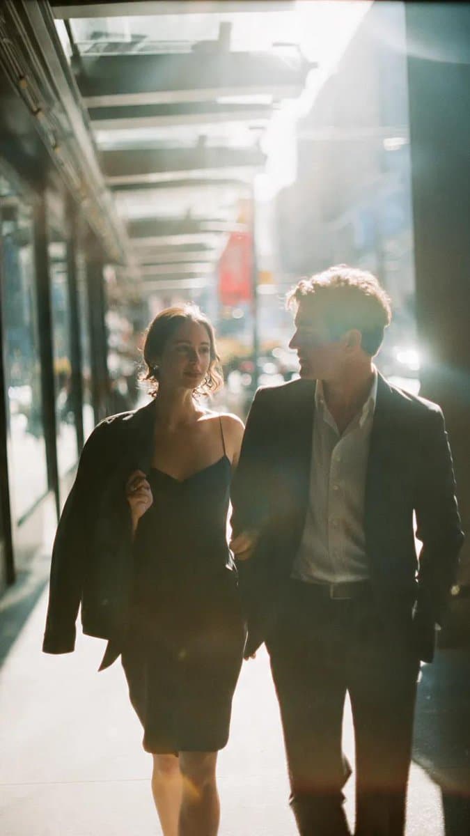 AI generated: A cinematic candid medium shot portrait of a man and a woman walking side by side along a bright urb...