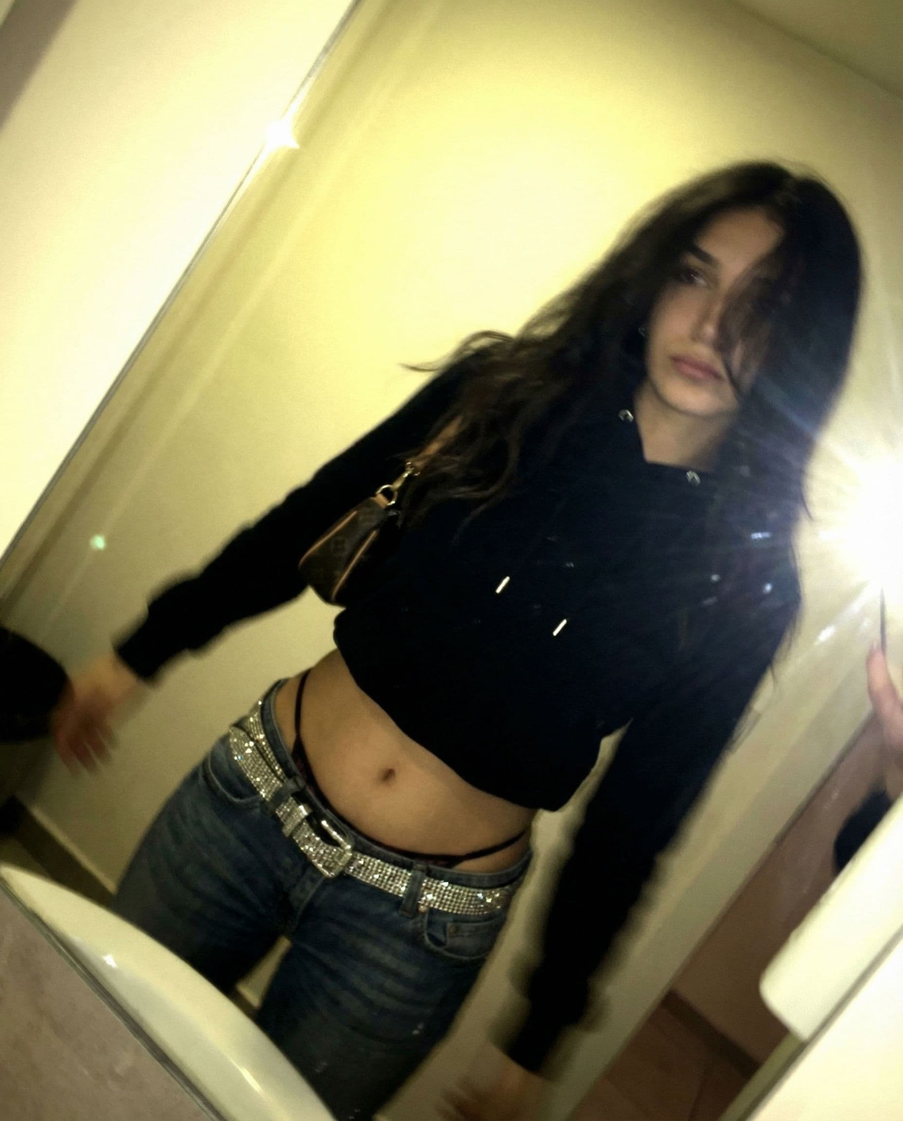 AI generated: a lo-fi 2015s-era, diagonally taken, low-quality iPhone photo of a 20-year-old baddie. The shot is i...
