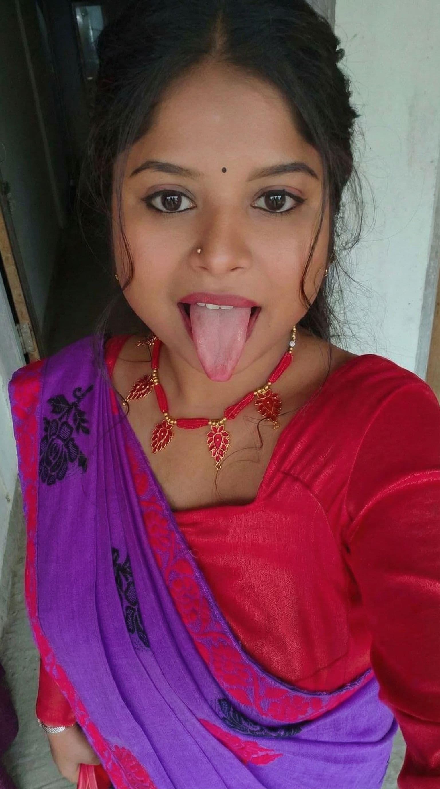 AI generated: Make her a hot model who is showing he long tongue