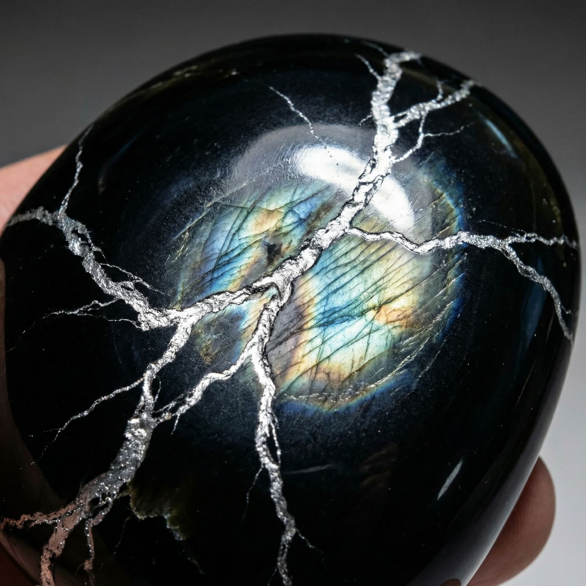 AI generated: Black obsidian with platinum veins flowing through it like lightening and it has a shine like Labrad...