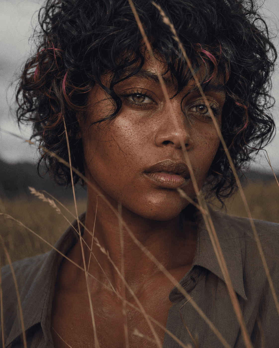 AI generated: Intimate close-up portrait in a quiet field, subject facing the camera directly with a calm serious ...