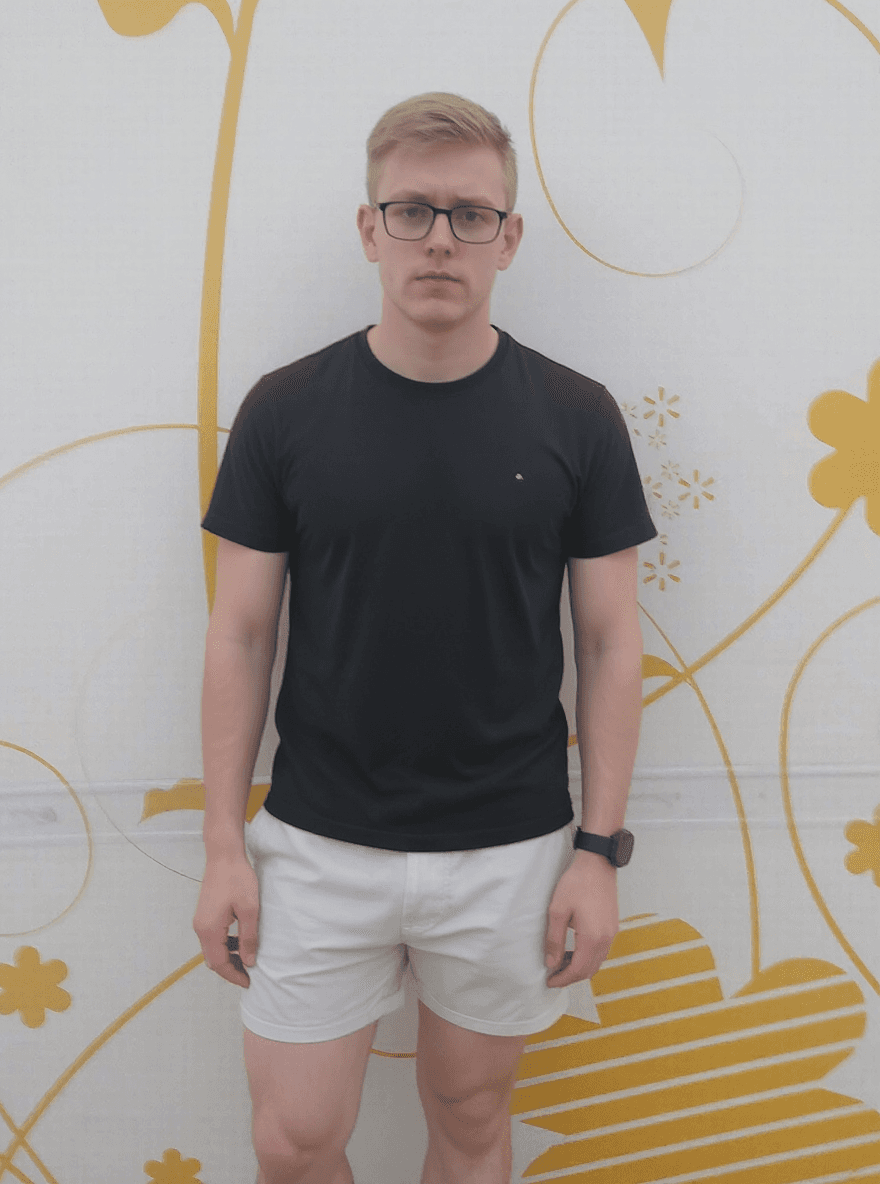 AI generated: Blonde nerdy young man with glasses embarrassed wearing tighty whities