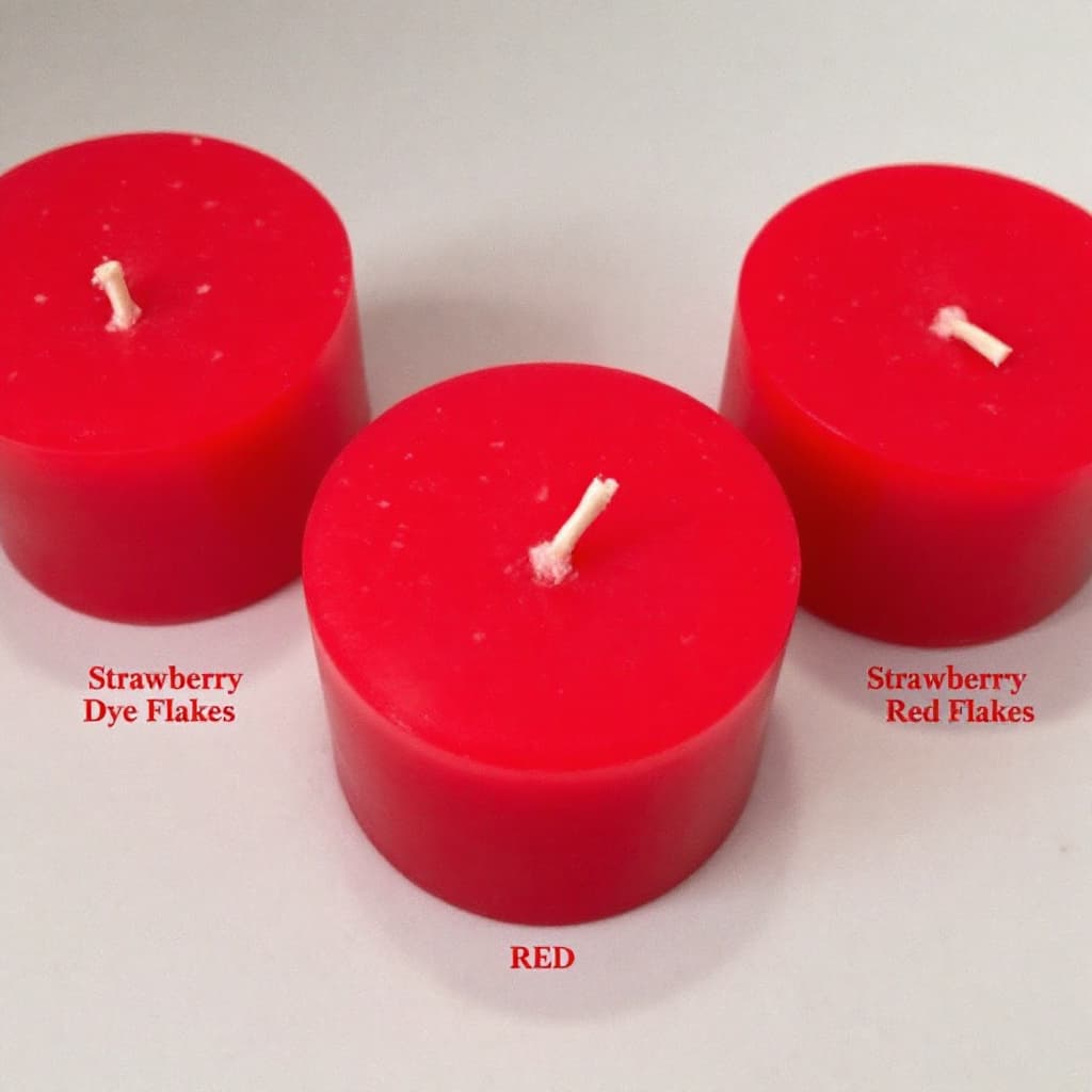 AI generated: Three round red candles containing strawberry-red dye flakes, which are used to colour wax for candl...
