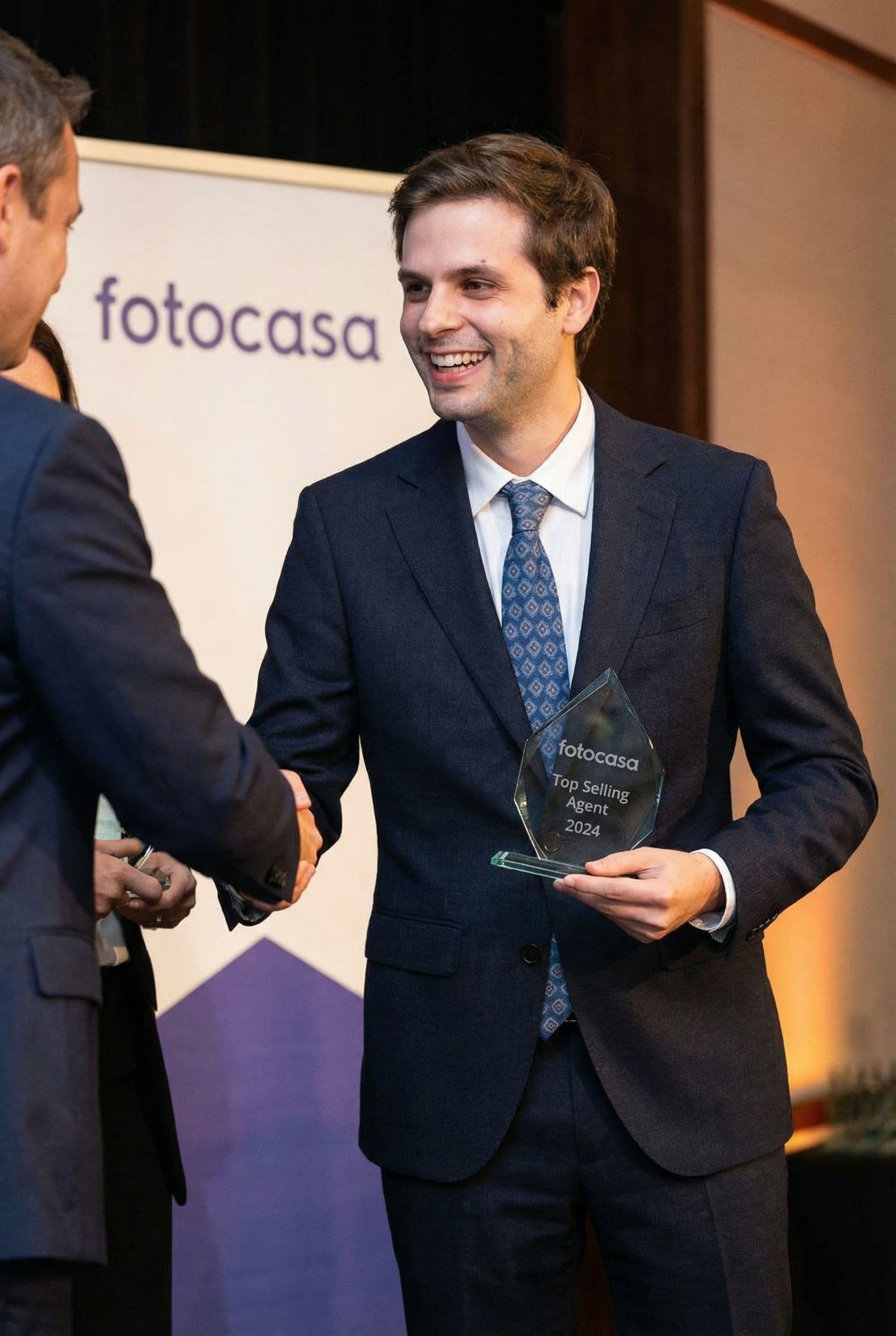 AI generated: The man is the top selling real estate agent of Fotocasa