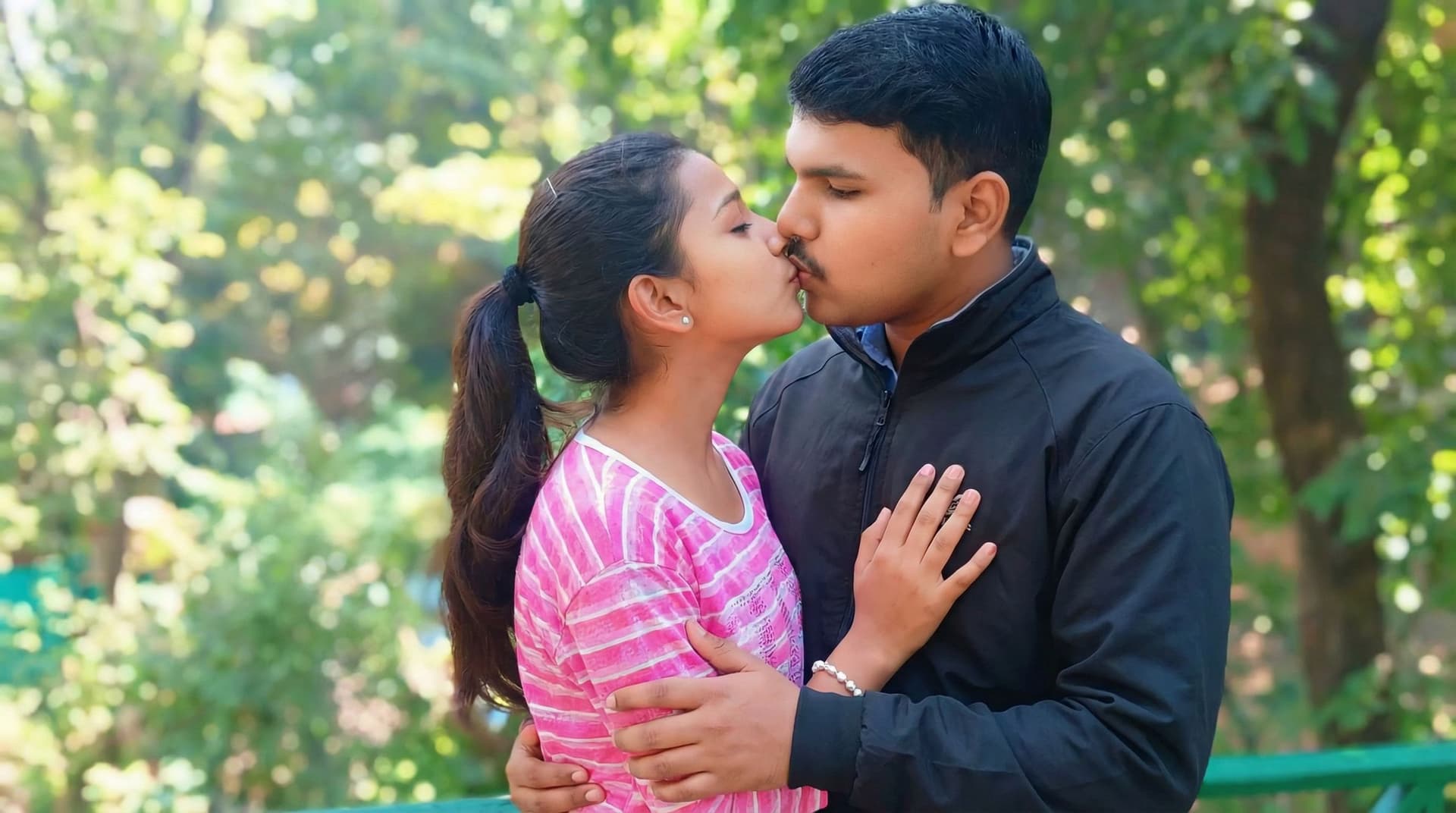 AI generated: Make them they are doing lip kissing each together and boy are doing to pressing girl breast.