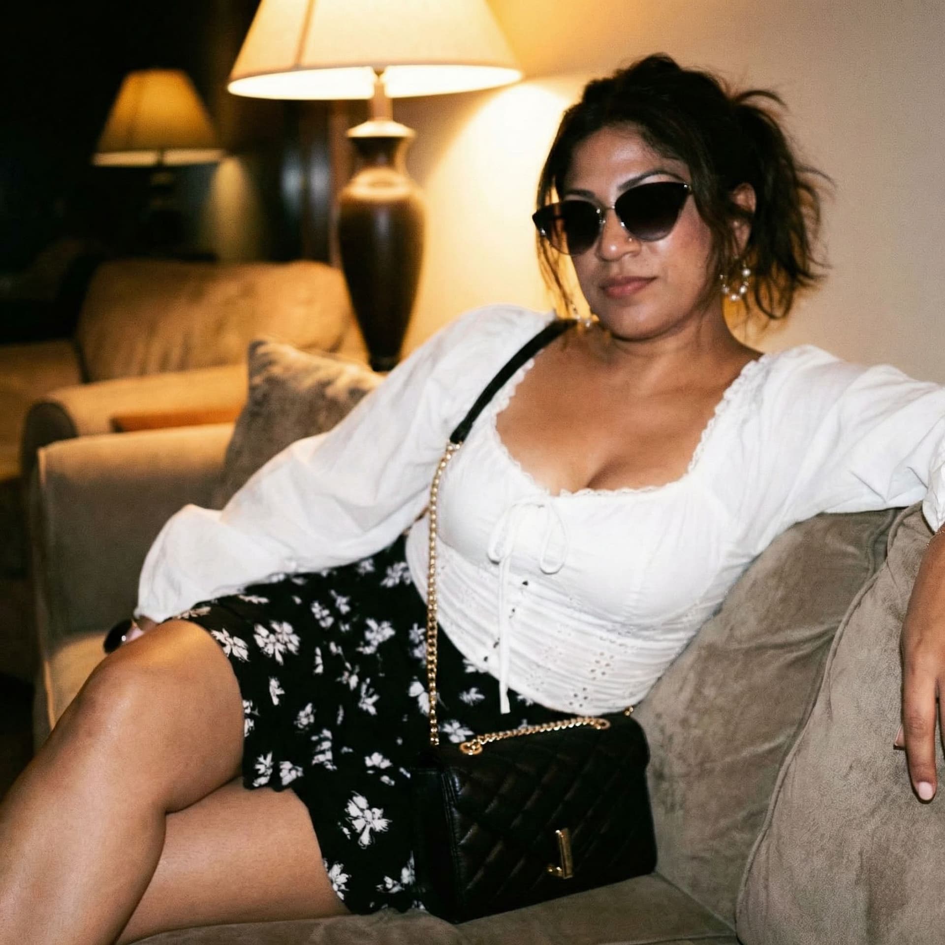 AI generated: Wearing same clothes, on a couch, close view, 35-year-old indian woman, busty body, at night, ponyta...