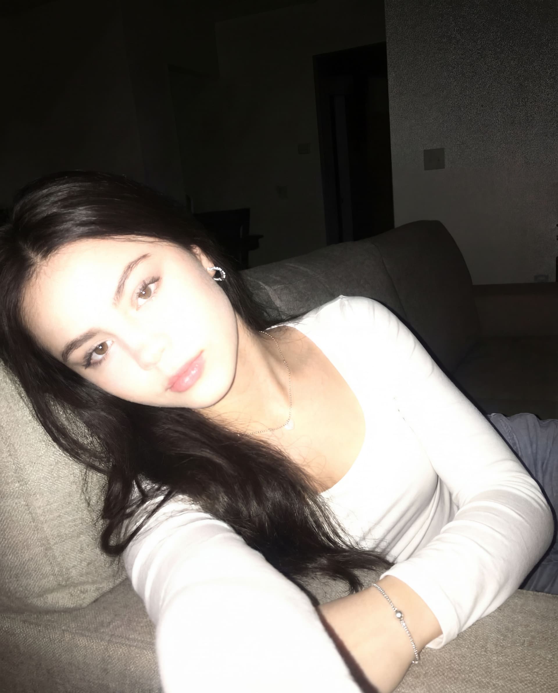 AI generated: Using the uploaded reference photo, create a standard iPhone selfie with flash. There's no clear sub...