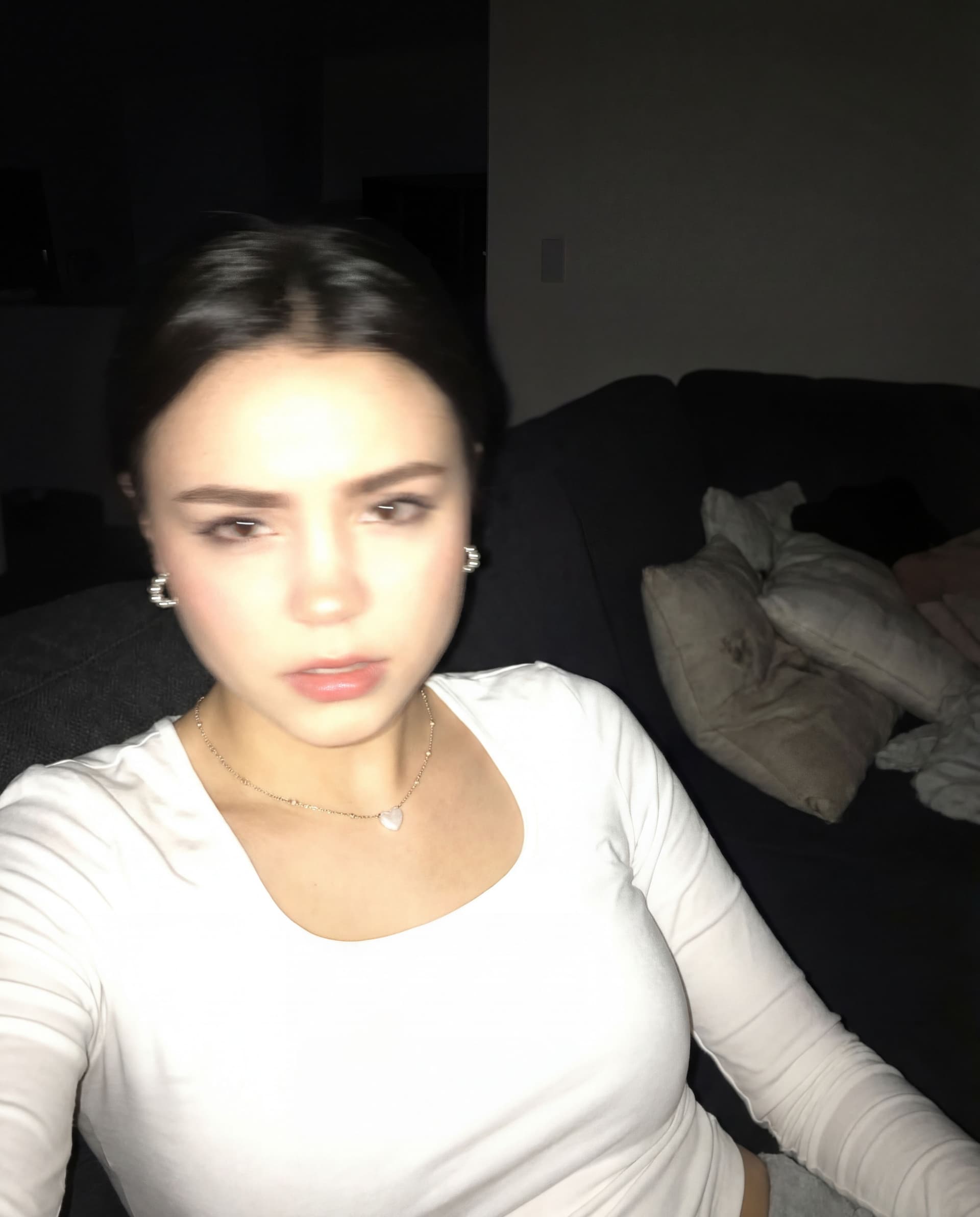 AI generated: Using the uploaded reference photo, create a standard iPhone selfie with flash. There's no clear sub...
